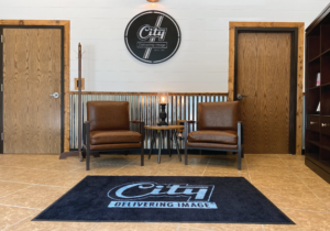 City uniforms and linen front lobby with a logo mat 