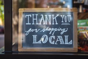 Sign that says thank you for shopping local in chalk